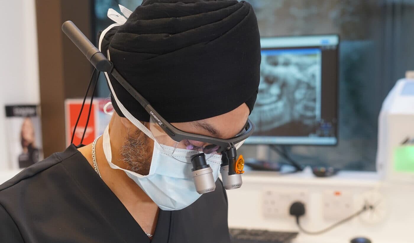 A dentist wearing magnifying loupes during implant treatment at Hermes London Dental Clinic
